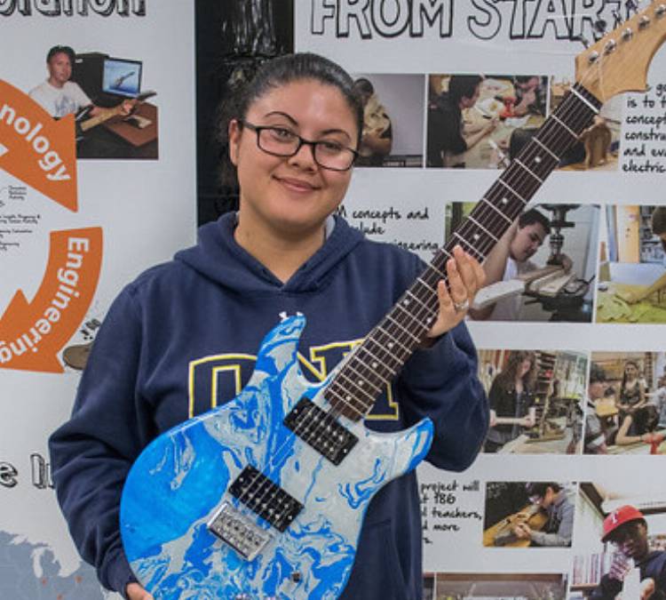 Edmonds CC scholarship recipient Violet Velazquez participated in an on-campus veterans guitar building workshop.